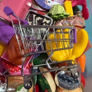 Miniature shopping cart with food and groceries
